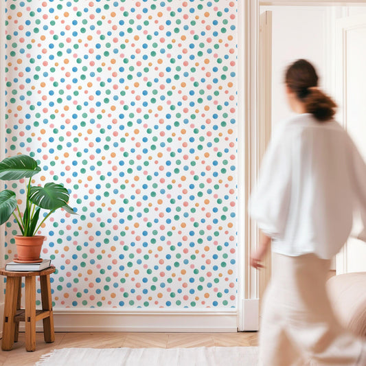 Minimalist room with Colorful Polka Dot Wallpaper and a woman walking by.
