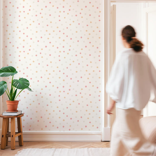 Minimalist room with Pink Polka Dot Wallpaper and a woman walking by.