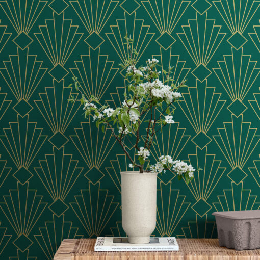 Green and gold art deco wallpaper behind side table with plant