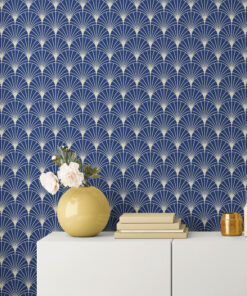 Blue arch art deco wallpaper on wall behind white cabinet with yellow and gold decor