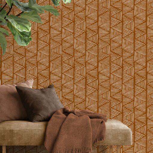 Geometric triangle wallpaper behind a bench seat next to a large shrub