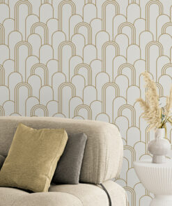 white and gold wallpaper in room with comfy modern armchair and side table with plant