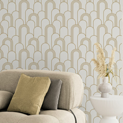 white and gold wallpaper in room with comfy modern armchair and side table with plant