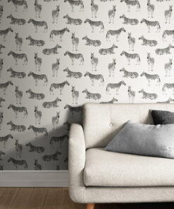 light zebra print wallpaper behind a comfy white sofa with cushions in a living room