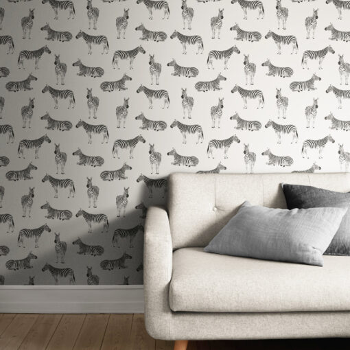 light zebra print wallpaper behind a comfy white sofa with cushions in a living room